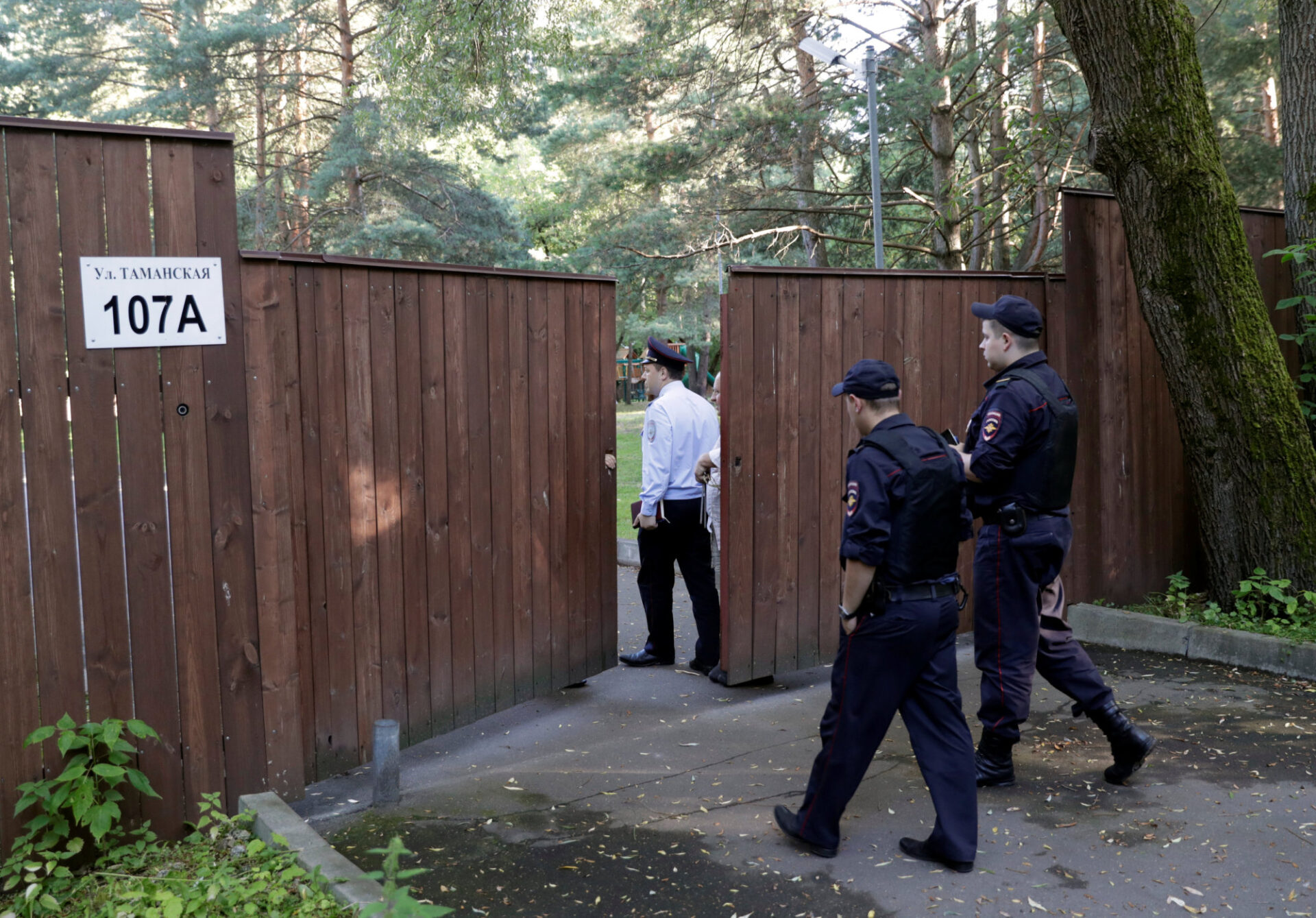Russian police officers enter a territory of a dacha compound used by U.S. diplomats for recreation, in Serebryany Bor residential area in the west of Moscow