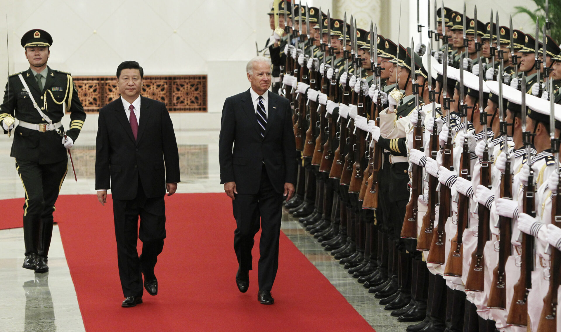 U.S. Vice President Biden and his Chinese counterpart Xi review the guards of honour during a welcome ceremony at the Great Hall of the People in Beijing